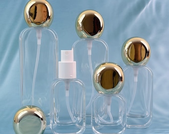 Juego de botellas de spray de vidrio transparente con tapa esférica dorada Glam, rellenables en varios tamaños para suero, bruma para el cuidado de la piel y artículos de tocador de viaje, diseño a prueba de fugas.