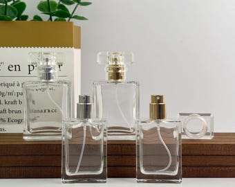 Frasco pulverizador cuadrado de vidrio de 30 ml y 50 ml, atomizador transparente recargable con tapa de cristal y bomba dorada/plateada, recipiente de lujo para fragancias, frascos de perfume.