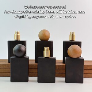 May include: Black rectangular perfume bottles with gold-colored spray tops and wooden sphere stoppers. The image includes the text "We have got you covered. Any damaged or missing items will be taken care of quickly, so you can shop worry free."