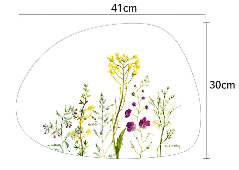 May include: A placemat with a white background and a watercolor floral design. The placemat is 16 inches wide and 12 inches tall. The floral design features yellow, purple, and white flowers and green foliage.