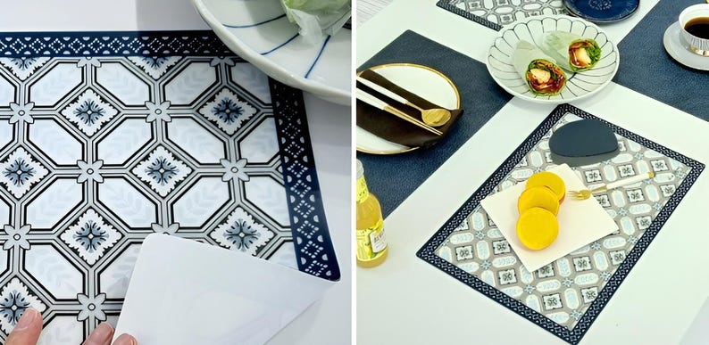 May include: A set of decorative placemats with a geometric pattern in white, gray, and navy blue. The placemats feature a border design and are shown with plates, cutlery, and food. The placemats are rectangular.