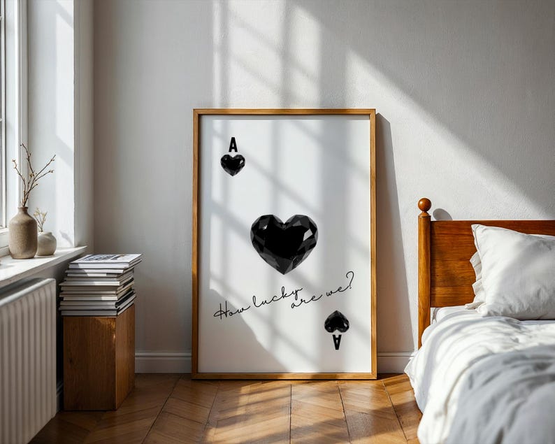 May include: A black and white poster with a large black heart and the text "How lucky are we?"  The heart is a playing card ace of spades.