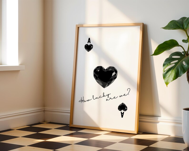 May include: A black and white printable art print with a stylized image of the Ace of Spades playing card. The text "How lucky are we?" is written in cursive below the card.
