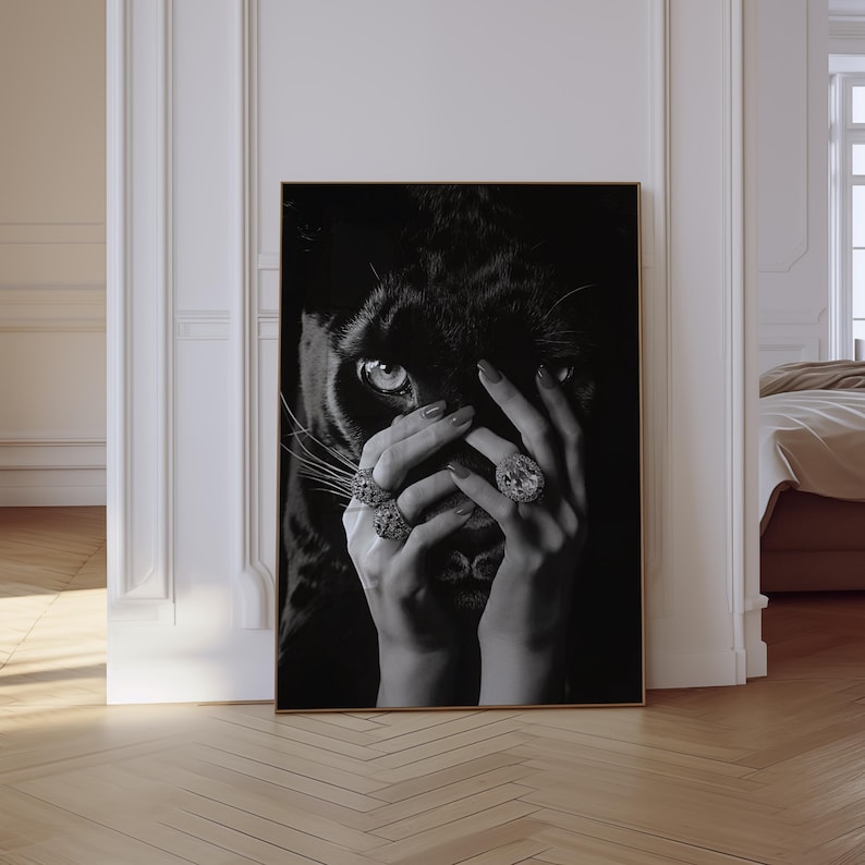 May include: Black and white photograph of a woman's hands covering her face. The woman is wearing large diamond rings. The background is a black panther.