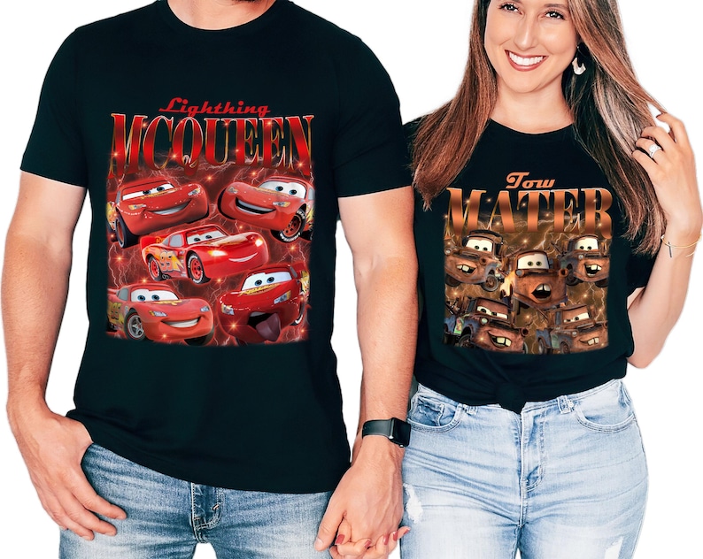 May include: Black t-shirts featuring characters from the animated movie Cars. One shirt displays Lightning McQueen with the text "Lightning McQueen". The other shirt shows Tow Mater with the text "Tow Mater".