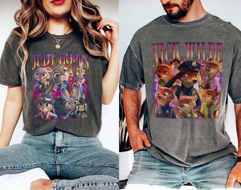 May include: Two grey t-shirts featuring characters from the animated film "Zootropolis." One shirt displays "JUDY HOPPS" with images of Judy Hopps and other characters. The other shirt shows "NICK WILDE" with images of Nick Wilde and other characters.