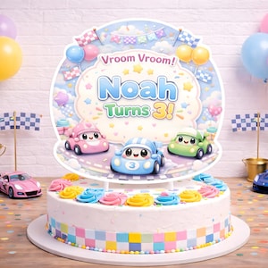 May include: A birthday cake with a car theme. The cake is decorated with colorful frosting and a topper that says "Noah Turns 3!" with cartoon cars. Balloons and toy cars are also present.