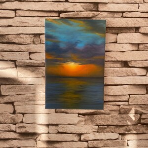 May include: A painting of a sunset over the ocean. The sky is a mix of blue, purple, and orange, with clouds reflecting in the water. The sun is setting in the distance, casting a warm glow over the scene.