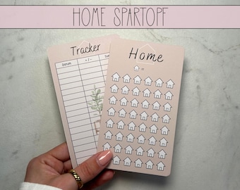 May include: Two pink printable sheets with the text "Home Spartopf" at the top. The left sheet is a tracker with the headings "Datum", "+/-", and "Sum". The right sheet has the word "Home" at the top and a grid of 49 small house icons.