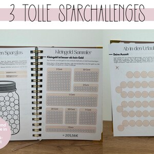 May include: A spiral-bound notebook with three different savings challenges. The first page shows a jar graphic for saving, the second has coin-saving charts, and the third has a vacation-themed chart. The notebook has the text "3 TOLLE SPARCHALLENGES".