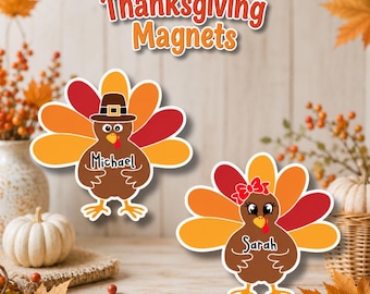 May include: Two turkey-shaped magnets with colorful orange, yellow, and red feathers. One turkey wears a black pilgrim hat and is labeled Michael, while the other wears a red bow and is labeled Sarah. The text Thanksgiving Magnets is above.