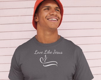 May include: A charcoal grey t-shirt with a white graphic design that says "Love Like Jesus" with a heart and cross symbol.