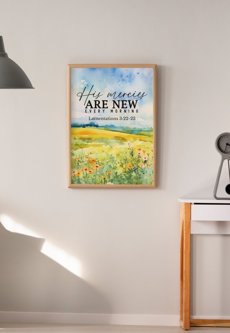 May include: A framed watercolor painting with a field of flowers and the text "His mercies are new every morning" with the scripture reference "Lamentations 3:22-23".