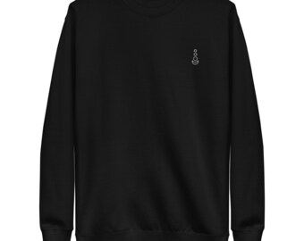 May include: A black sweatshirt with a small white design of a crescent moon and circles on the left chest.