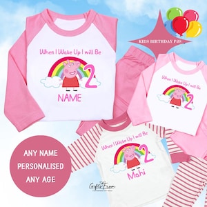 May include: Pink and white kids' pajamas with a Peppa Pig graphic, rainbow, and the number 2. The text "When I Wake Up I will Be" is above the graphic. The pajamas are personalized with a name.