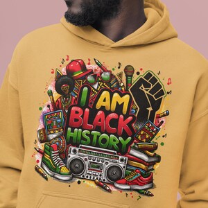 May include: A mustard yellow hoodie with a colorful graphic print of a black fist, a boombox, books, and the text "I AM BLACK HISTORY".