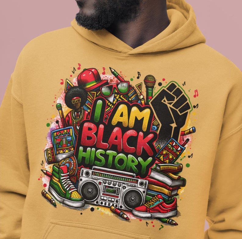 May include: A mustard yellow hoodie with a colorful graphic print of a black fist, a boombox, books, and the text "I AM BLACK HISTORY".