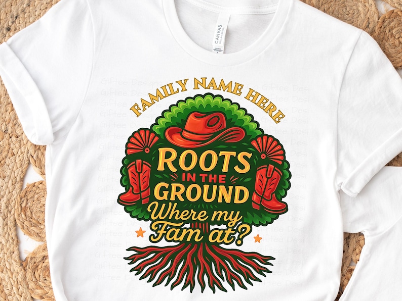 May include: White t-shirt with a colorful graphic design. The design features a tree with roots, a cowboy hat, boots, and the text "Roots in the Ground Where my Fam at?" in a stylized font. The words "Family Name Here" are arched above the tree.
