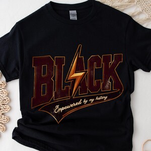 May include: Black t-shirt with a gold lightning bolt graphic and the text "Black Empowered by my history".