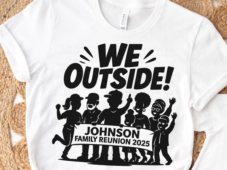 May include: White t-shirt with a black graphic that reads "WE OUTSIDE!" above a silhouette of a family holding a banner that says "JOHNSON FAMILY REUNION 2025". The shirt is made of a soft material.