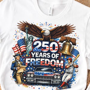 Könnte beinhalten: Weißes T-Shirt mit einem patriotischen Design, das 250 Jahre Freiheit feiert. Die Grafik zeigt einen Adler, die Freiheitsstatue, die Liberty Bell, einen Baseballspieler und ein klassisches Auto in Rot, Weiß und Blau.