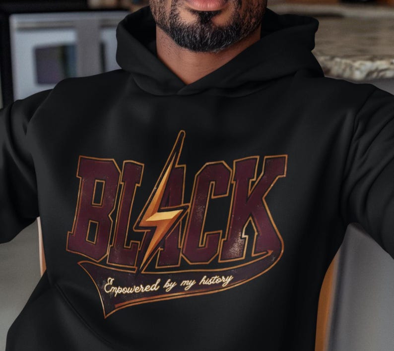 May include: Black hoodie with a vintage-style graphic that says "BLACK" with a lightning bolt and the text "Empowered by my history".