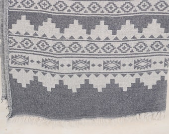 Peut inclure: Textile à motifs gris et blancs avec un motif géométrique. Le tissu présente des formes et des motifs répétitifs, avec un bord effiloché. La palette de couleurs est une combinaison de gris et de blanc.