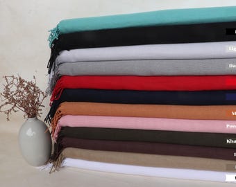 May include: A stack of 12 different coloured scarves, including mint, black, light grey, dark grey, red, navy, mustard, powder pink, khaki green, brown, beige, and white.
