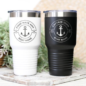 May include: Two stainless steel tumblers with a white and black finish. The tumblers feature a nautical design with an anchor and the text "First Mate Amy" and "Captain John".