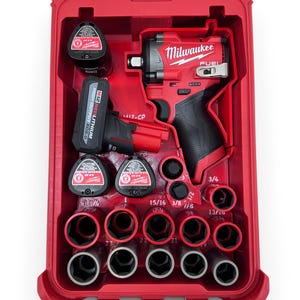 Può includere: Kit di chiave a impulsi Milwaukee FUEL rossa in una custodia rossa. Include una chiave, batterie e prese. La custodia è aperta, rivelando gli strumenti. La chiave ha un'impugnatura nera e il testo "Milwaukee FUEL".