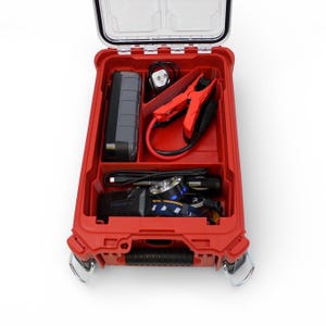 May include: A red toolbox with a clear lid, open to reveal a black power bank, red jumper cables, a headlamp, and other accessories. The toolbox has a handle and metal latches.