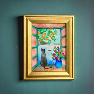 May include: A framed watercolor painting depicts a black cat gazing out a window at a landscape with orange trees and a sailboat. A blue vase of flowers sits on the windowsill. The frame is gold.