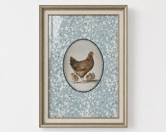 May include: A framed wall art print featuring a central oval illustration of a brown hen with three small chicks. The background is a light blue pattern of white floral sprigs. The frame is a metallic gold with a textured, beaded edge detail.