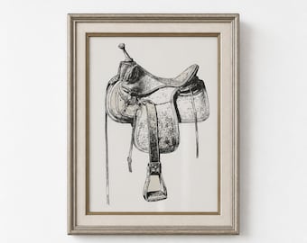 May include: A framed monochrome print of a Western saddle. The saddle features stirrups, straps, and a seat. The print is in a silver-coloured frame, ideal for equestrian-themed interiors.