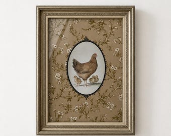 May include: A framed wall art piece featuring a central oval illustration of a brown hen with three small chicks. The background is a tan paper with a repeating white floral vine pattern. The frame is a metallic silver with a textured border.