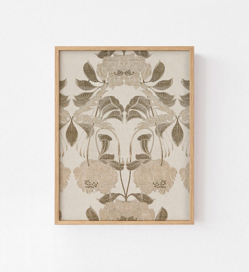 May include: A framed wall art print featuring a symmetrical, repeating botanical pattern in shades of beige, cream, and muted brown. The design displays stylized flowers and leaves with intricate line work, enclosed in a light-toned wooden frame.