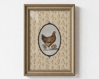 May include: A framed wall art piece featuring a central oval illustration of a brown hen with three small chicks. The background within the frame is a light beige paper with a repeating pattern of small, delicate brown floral sprigs.