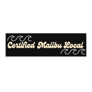 May include: Black and white graphic with the text "Certified Malibu Local" in a cream color. The text is in a retro font style. There are stylized waves on either side of the text.