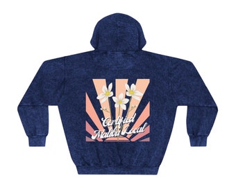 May include: A navy blue hoodie with a vintage-style graphic on the back. The graphic features a pink and orange sunrise with white flowers and the text "Certified Malibu Local".