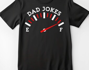 May include: Black t-shirt with a gauge graphic that reads "DAD JOKES" at the top. The gauge has red and white markings, with the needle pointing towards the "F" for full. The "E" and "F" are white. A humorous apparel item.