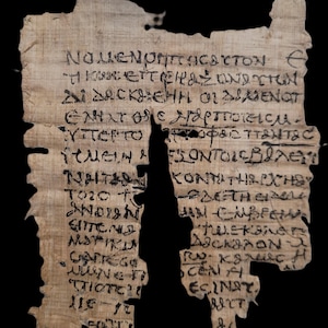 May include: A fragment of a papyrus scroll with ancient Greek writing in black ink. The text is partially damaged and missing, but the remaining text is legible. The papyrus is a light brown colour and has a rough texture.