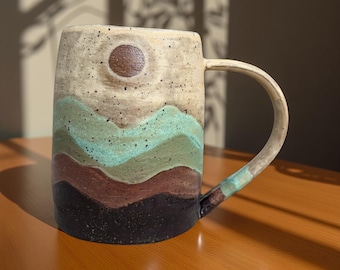 Ceramic turquoise mountain mug with sun and moon