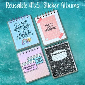 May include: Four spiral-bound 4"x5" sticker albums. One is light blue with text "IT'S NOT HOARDING IF IT'S STICKERS" and a rainbow. One is pink with "I have a sticker situationship". One is grid-patterned with "Commitment Issues" and "collect not commit" text. One is black and white speckled with "STICKER BOOK" text.