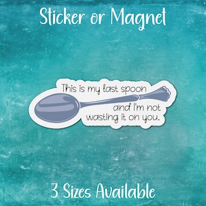 May include: A white sticker or magnet with a blue spoon and the text "This is my last spoon and I'm not wasting it on you."