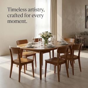 May include: A wooden dining table with six matching chairs, set with white bowls, clear glasses, and a vase of white calla lilies. The text "Timeless artistry, crafted for every moment." is displayed in the upper left corner of the image.