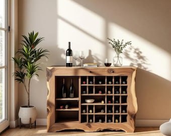 May include: Wooden wine cabinet with a natural edge design. The cabinet features multiple compartments for wine bottles, glasses, and a small bowl. A bottle of wine and two glasses are on top. A potted plant is to the left.