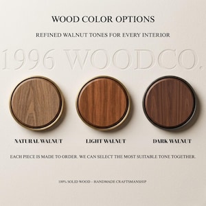 May include: Three circular wood samples labelled Natural Walnut, Light Walnut, and Dark Walnut. The text reads WOOD COLOUR OPTIONS, REFINED WALNUT TONES FOR EVERY INTERIOR, 1996 WOODCO., EACH PIECE IS MADE TO ORDER, and 100% SOLID WOOD &ndash; HANDMADE CRAFTSMANSHIP.