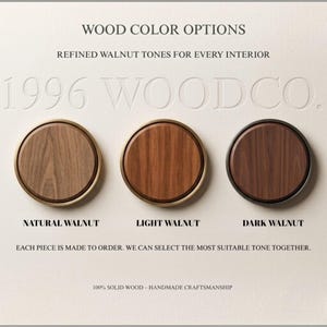 May include: Three circular wood samples labelled Natural Walnut, Light Walnut, and Dark Walnut. The text reads: WOOD COLOR OPTIONS, REFINED WALNUT TONES FOR EVERY INTERIOR, 1996 WOODCO., EACH PIECE IS MADE TO ORDER, 100% SOLID WOOD &ndash; HANDMADE CRAFTSMANSHIP.