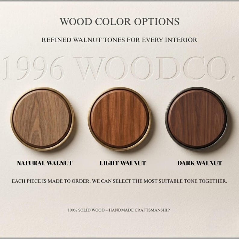 May include: Three circular wood samples labelled Natural Walnut, Light Walnut, and Dark Walnut. The text reads: WOOD COLOR OPTIONS, REFINED WALNUT TONES FOR EVERY INTERIOR, 1996 WOODCO., EACH PIECE IS MADE TO ORDER, 100% SOLID WOOD &ndash; HANDMADE CRAFTSMANSHIP.