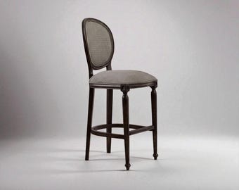 May include: A dark brown bar stool with a woven back and a patterned seat. The stool has four legs and a footrest. The seat is approximately 40 cm wide and 40 cm deep. The overall height of the stool is approximately 107 cm.